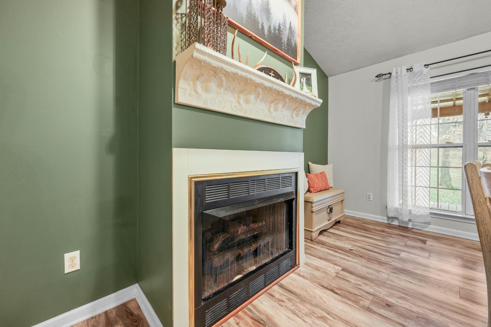 1201 Gallion Road Cumberland Furnace, TN 37051 - Photo 12 of 29 a view of a livingroom with wooden floor and a fireplace