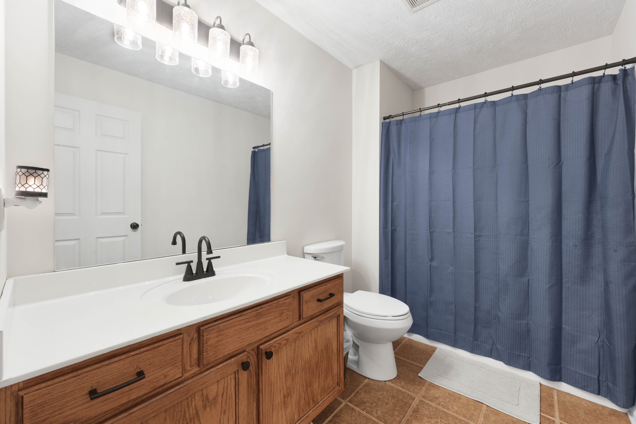 1201 Gallion Road Cumberland Furnace, TN 37051 - Photo 14 of 29 a bathroom with a sink a toilet a shower and a mirror