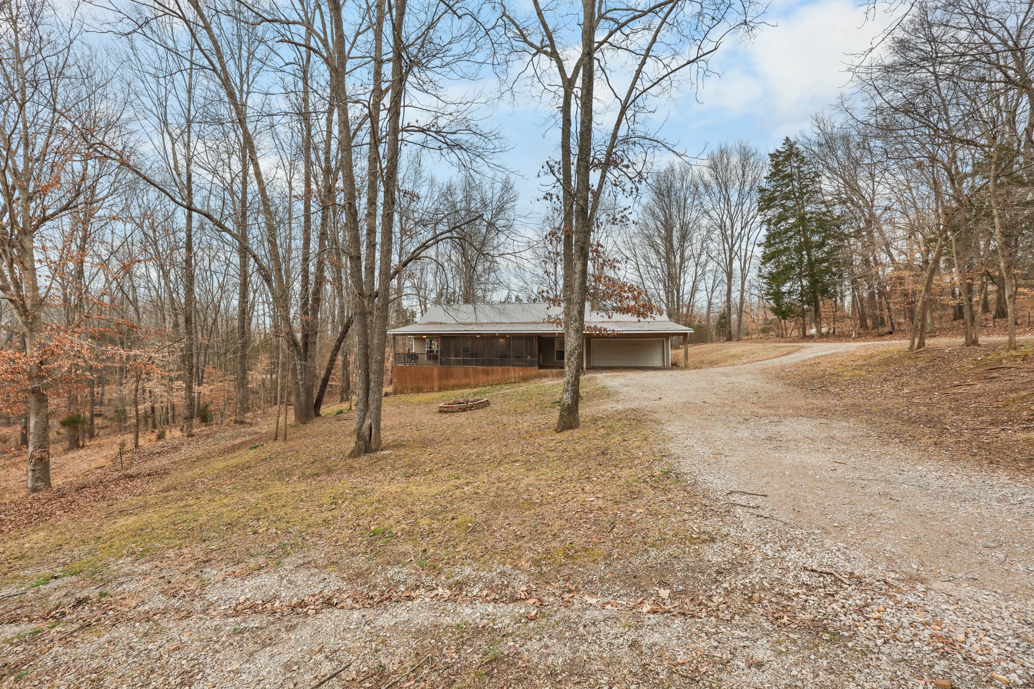1201 Gallion Road Cumberland Furnace, TN 37051 - Photo 23 of 29 a house with trees in front of it
