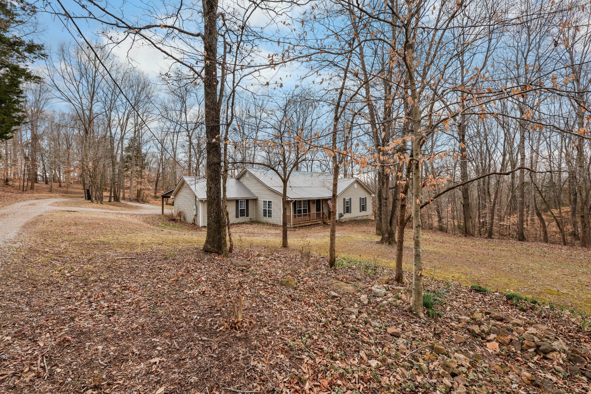 1201 Gallion Road Cumberland Furnace, TN 37051 - Photo 3 of 29 a backyard of a house with lots of tall trees