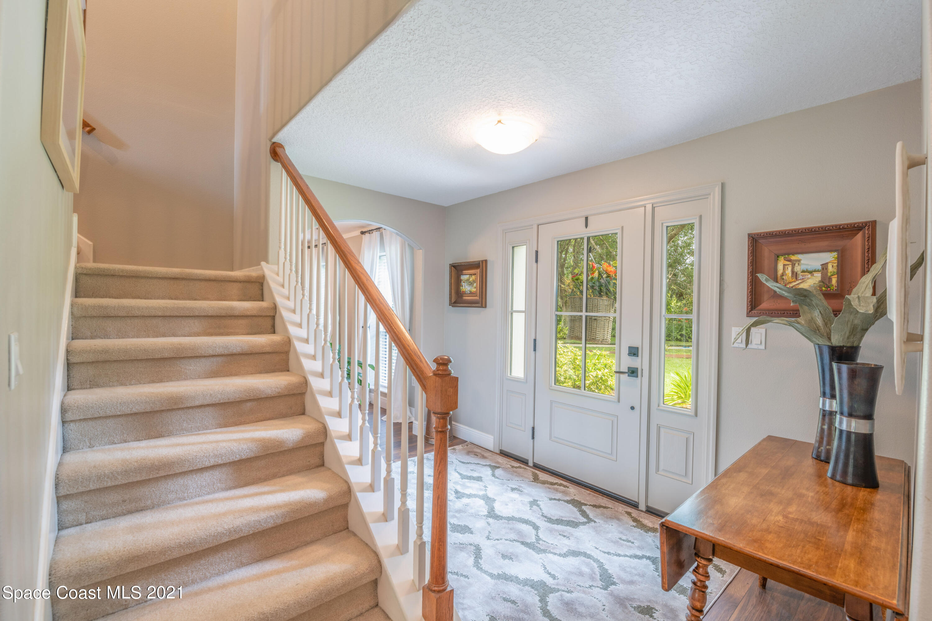4155 Turtle Mound Road Melbourne, FL 32934 - Photo 12 of 33 a view of an entryway with wooden floor and door