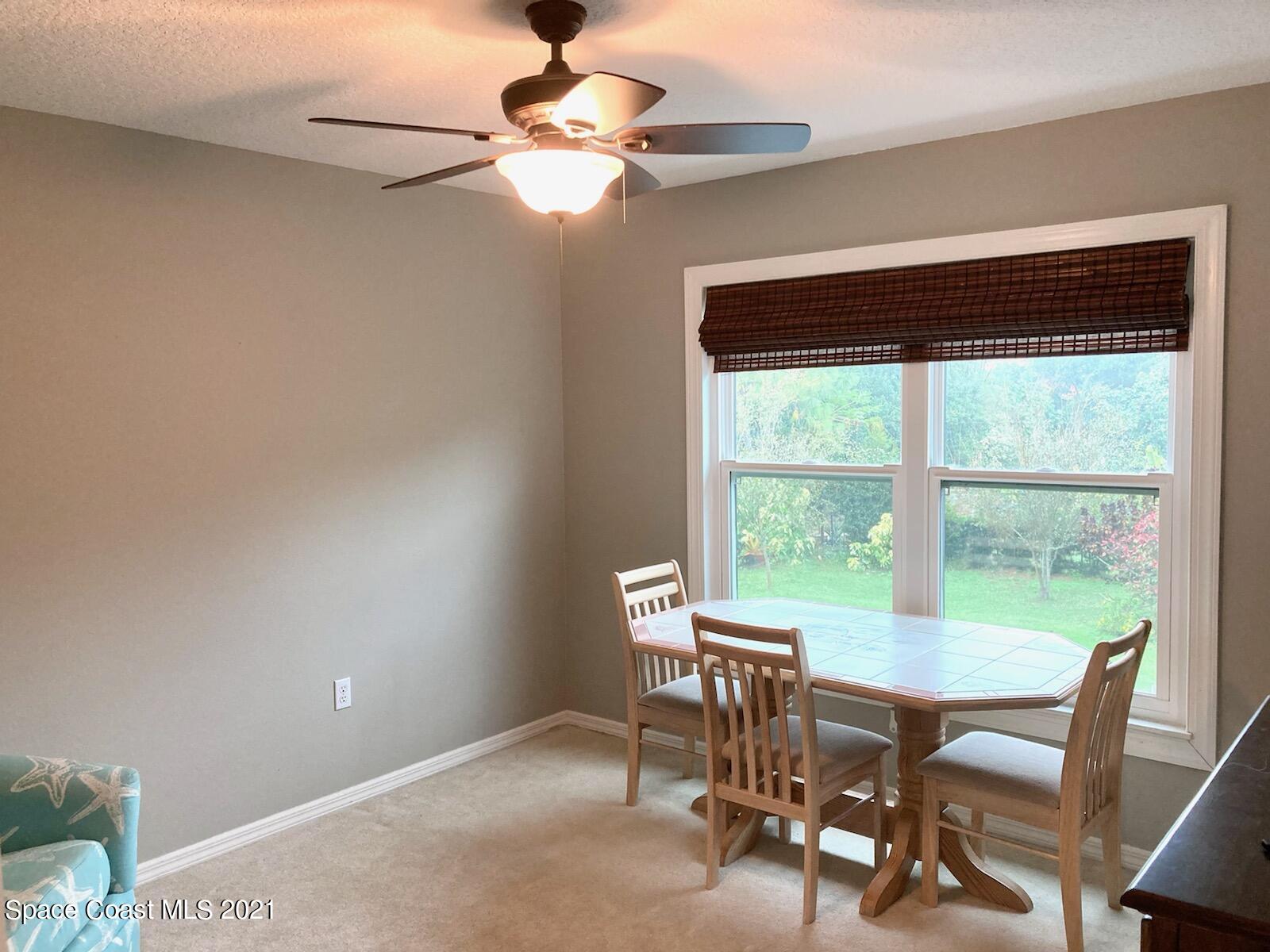 4155 Turtle Mound Road Melbourne, FL 32934 - Photo 17 of 33 a view of a dining room with furniture window and outside view