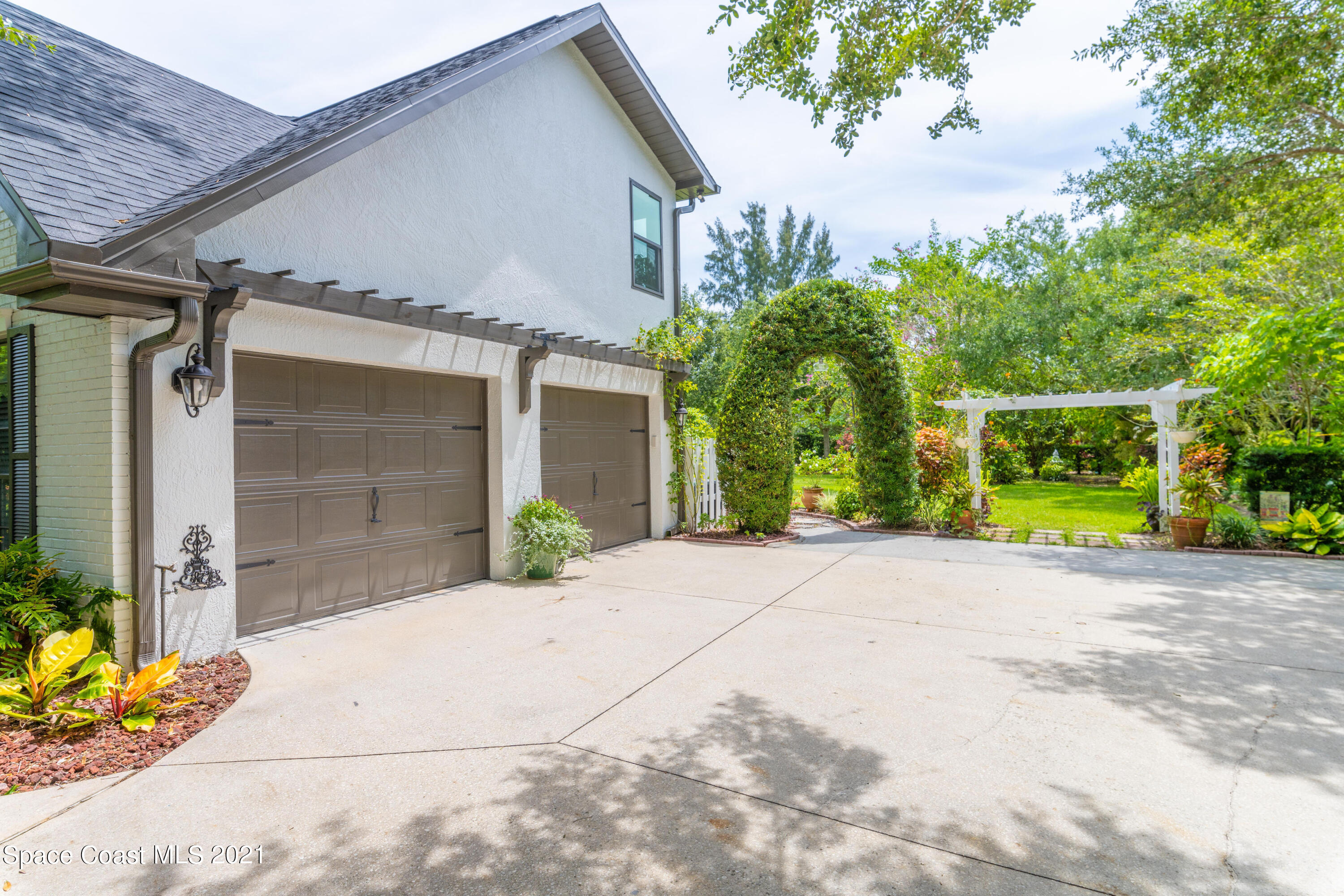 4155 Turtle Mound Road Melbourne, FL 32934 - Photo 26 of 33 a view of a house with a yard and potted plants