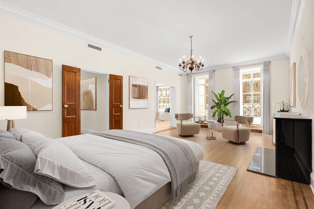 435 East 52nd Street, Unit 3A Manhattan, NY 10022 - Photo 10 of 35 a bedroom with bed and a couch