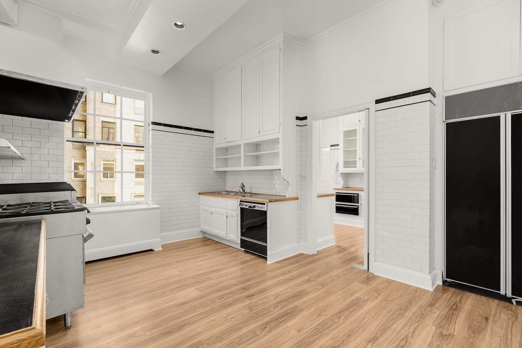 435 East 52nd Street, Unit 3A Manhattan, NY 10022 - Photo 13 of 35 a kitchen with stainless steel appliances a refrigerator and a stove top oven