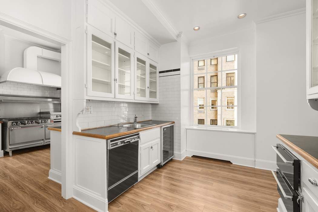 435 East 52nd Street, Unit 3A Manhattan, NY 10022 - Photo 14 of 35 a kitchen with stainless steel appliances granite countertop a stove and a sink