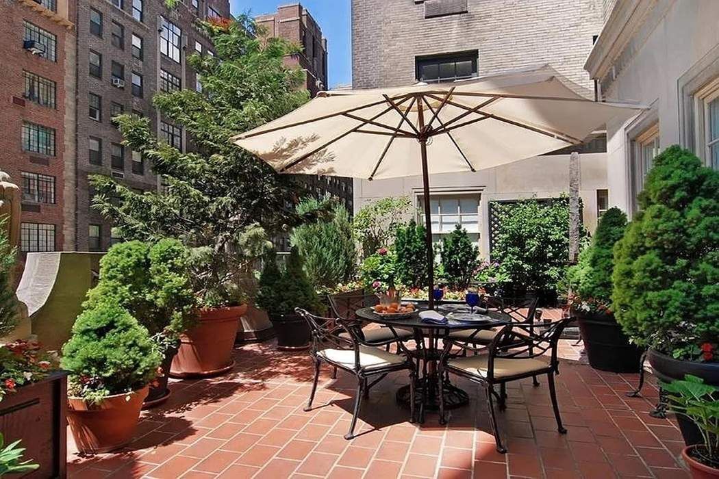 435 East 52nd Street, Unit 3A Manhattan, NY 10022 - Photo 17 of 35 a patio with a patio table and chairs