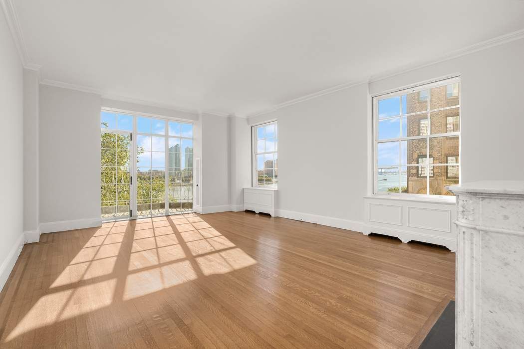 435 East 52nd Street, Unit 3A Manhattan, NY 10022 - Photo 28 of 35 a view of an empty room with wooden floor and a window