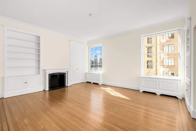 a view of a living room hardwood floor and a large window