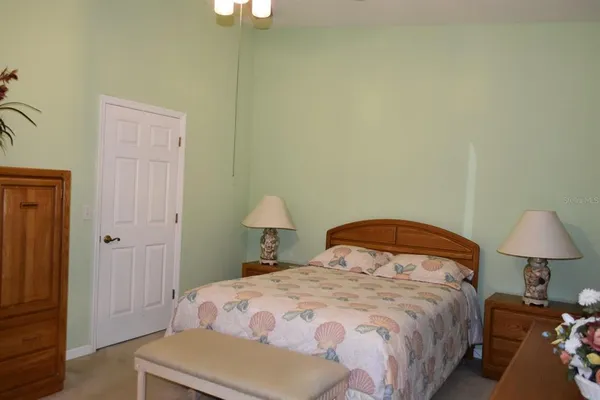 a bedroom with a bed and a lamp