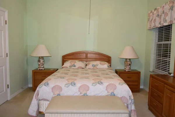 a bedroom with a bed and a lamp on table