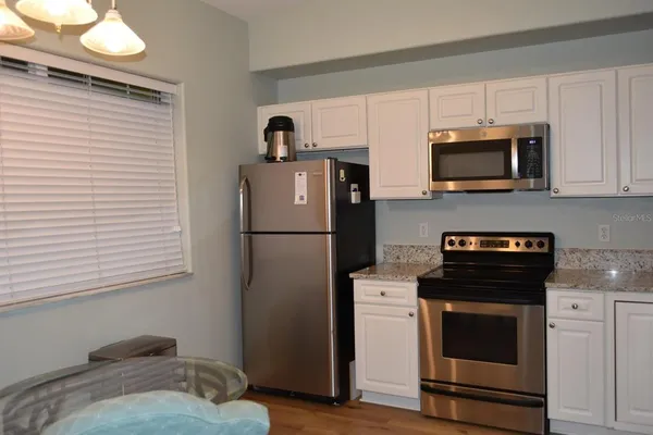 a kitchen with a refrigerator stove and microwave