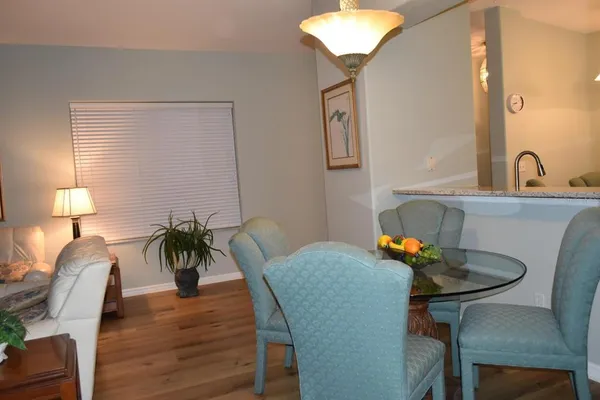 a view of a dining room with furniture and wooden floor
