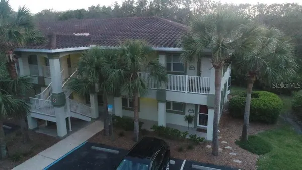 a aerial view of a house with a yard table and chairs