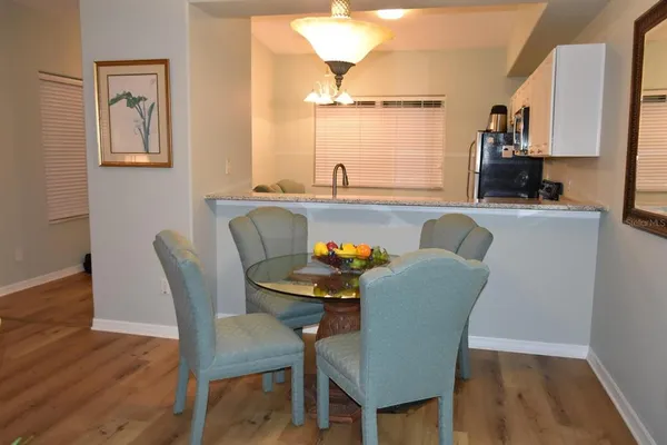 a dining room with furniture and wooden floor