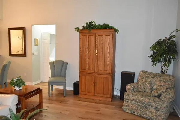 a living room with furniture and a potted plant