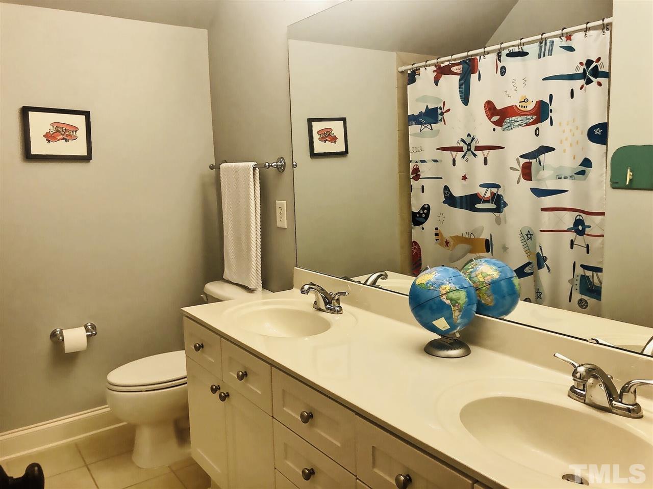 9328 Tabriz Point Raleigh, NC 27614 - Photo 17 of 29 a bathroom with a granite countertop toilet sink and mirror