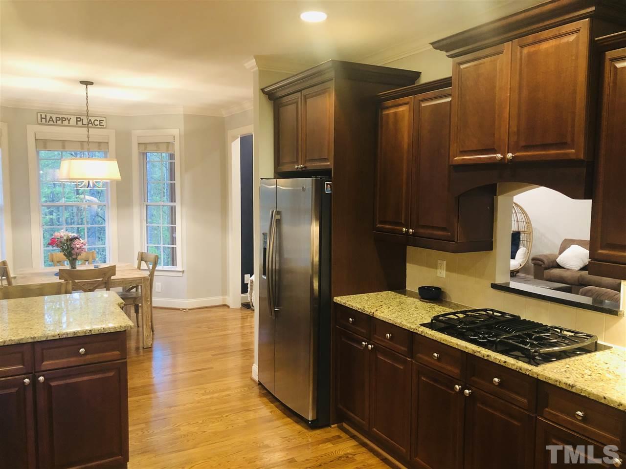 9328 Tabriz Point Raleigh, NC 27614 - Photo 3 of 29 a kitchen with stainless steel appliances granite countertop a stove a refrigerator and a granite counter tops
