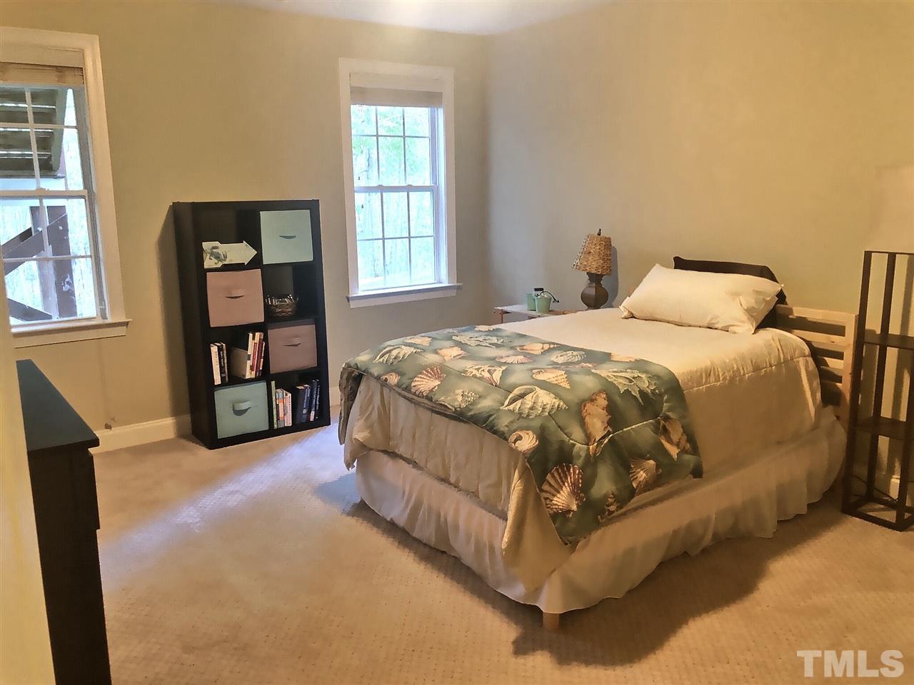 9328 Tabriz Point Raleigh, NC 27614 - Photo 23 of 29 a bed sitting in a bedroom next to a window