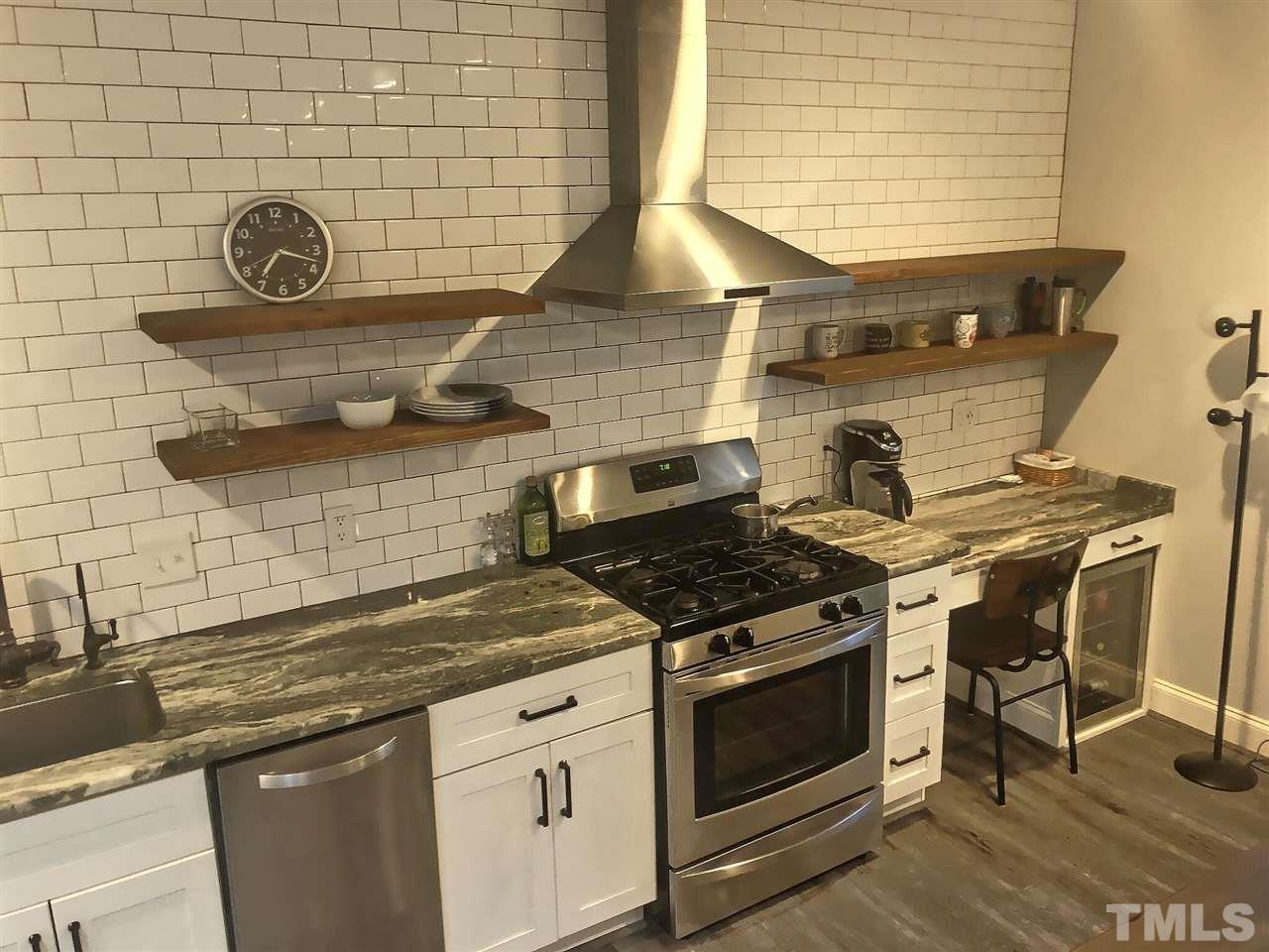 9328 Tabriz Point Raleigh, NC 27614 - Photo 4 of 29 a stove top oven sitting inside of a kitchen