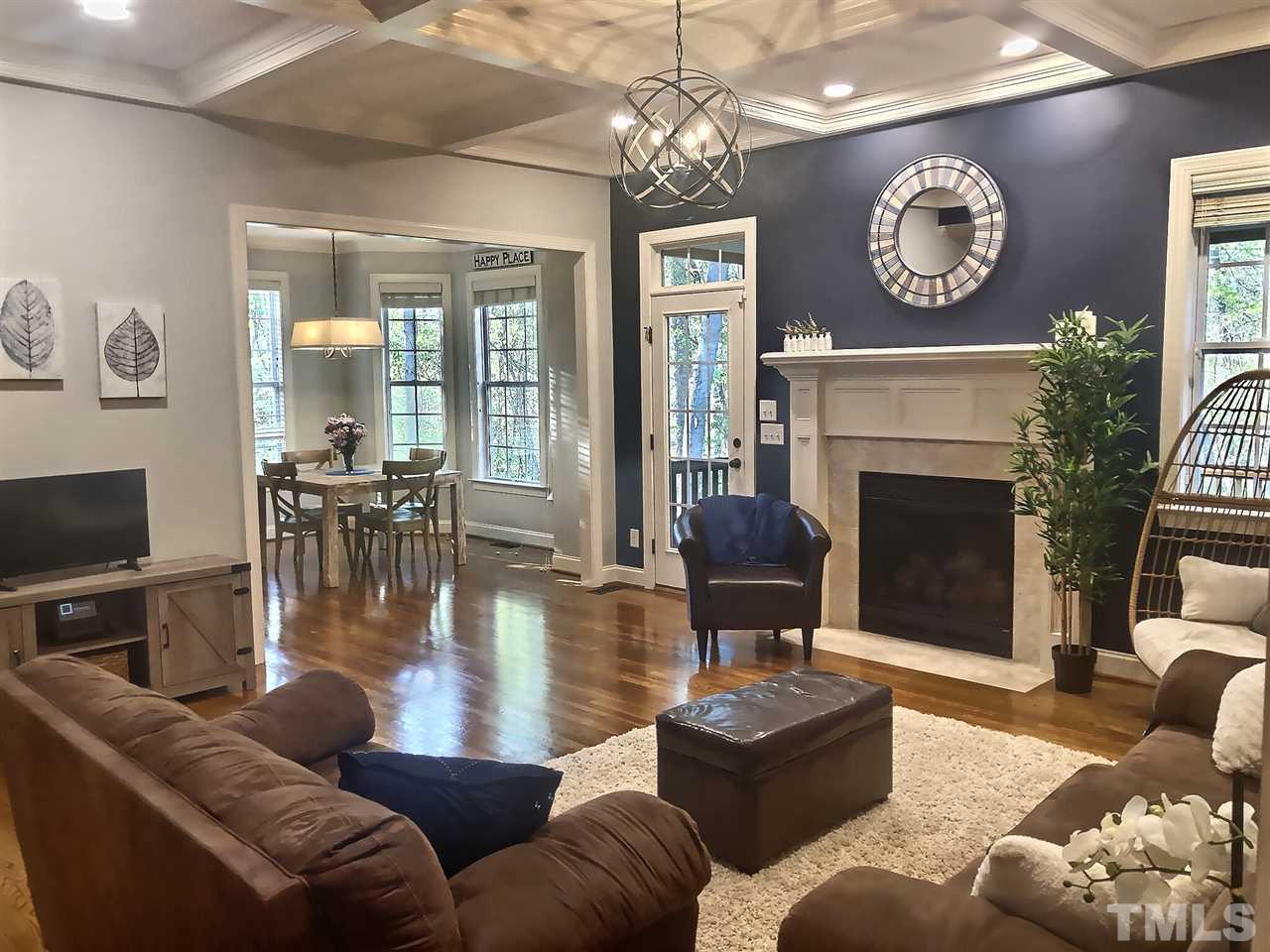 9328 Tabriz Point Raleigh, NC 27614 - Photo 6 of 29 a living room with furniture a fireplace and a flat screen tv