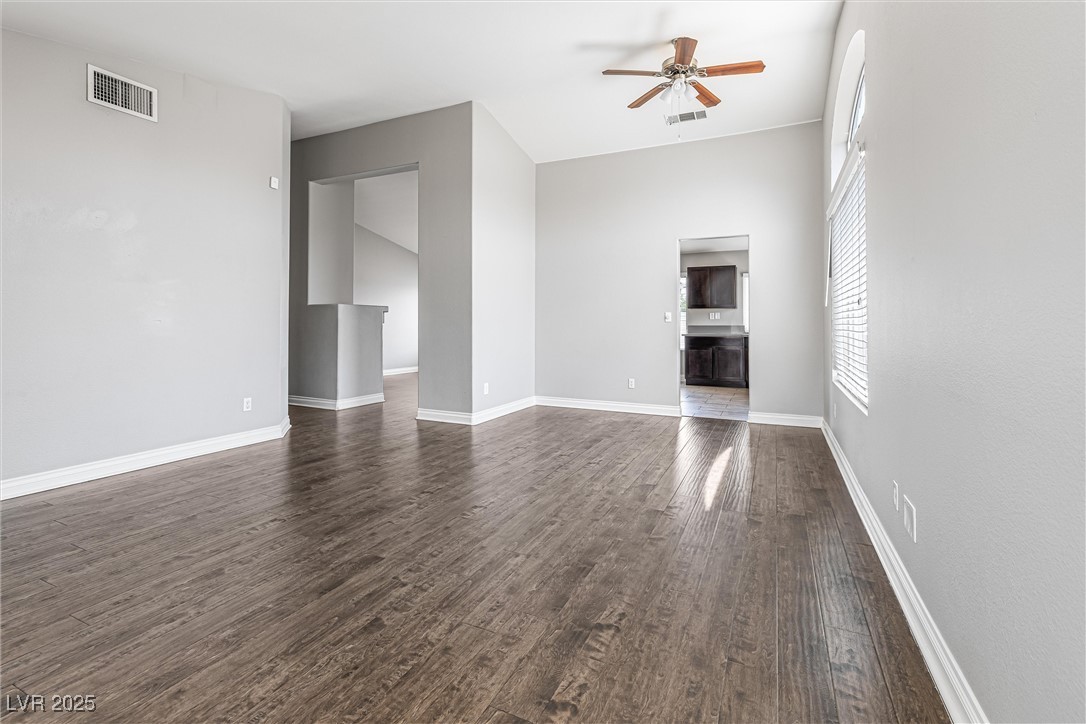 8878 Haviland Road Las Vegas, NV 89123 - Photo 11 of 58 Unfurnished living room featuring dark wood-type flooring and ceiling fan