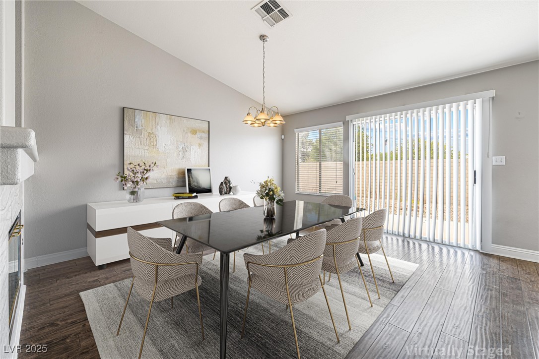 8878 Haviland Road Las Vegas, NV 89123 - Photo 17 of 58 Virtully Staged Dining area featuring lofted ceiling, wood finished floors, and a chandelier