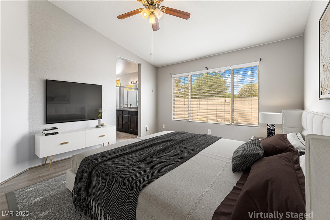 8878 Haviland Road Las Vegas, NV 89123 - Photo 26 of 58 Virtually Staged Bedroom with vaulted ceiling, wood finished floors, ensuite bath, and ceiling fan