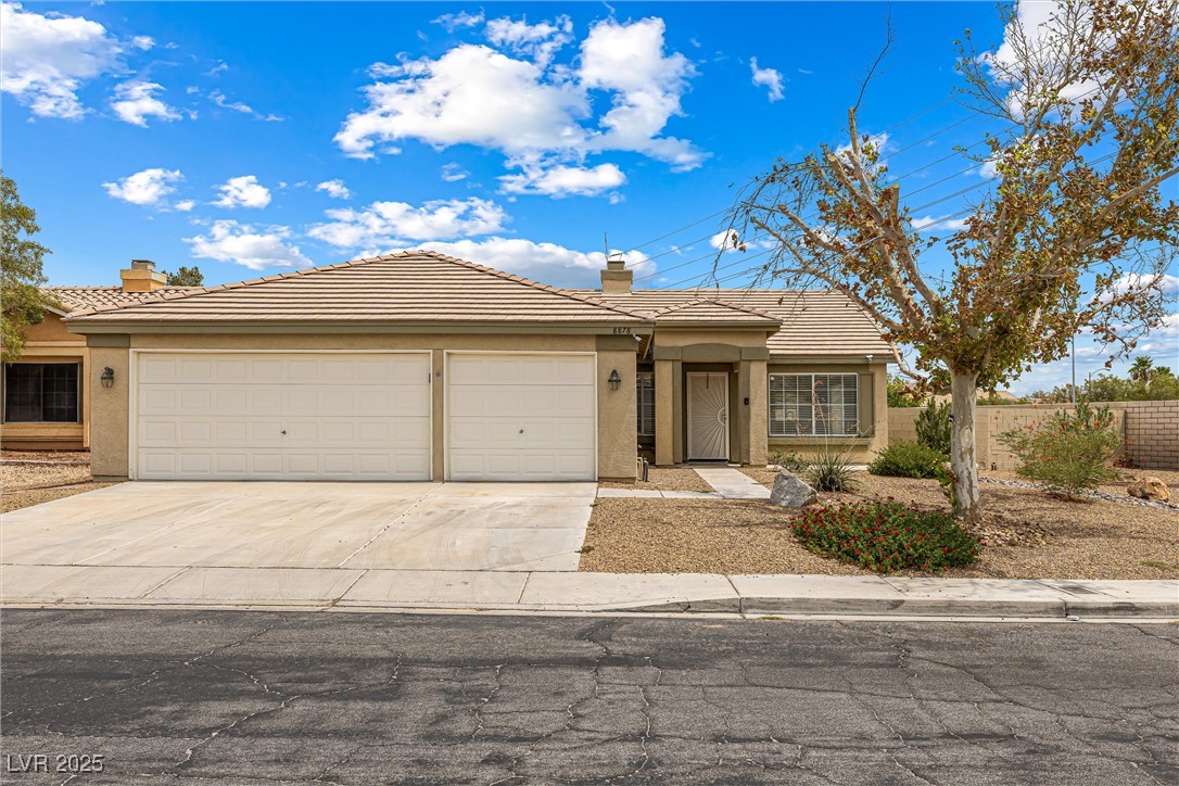 8878 Haviland Road Las Vegas, NV 89123 - Photo 3 of 58 Ranch-style home with stucco siding, a tiled roof, a garage, and concrete driveway