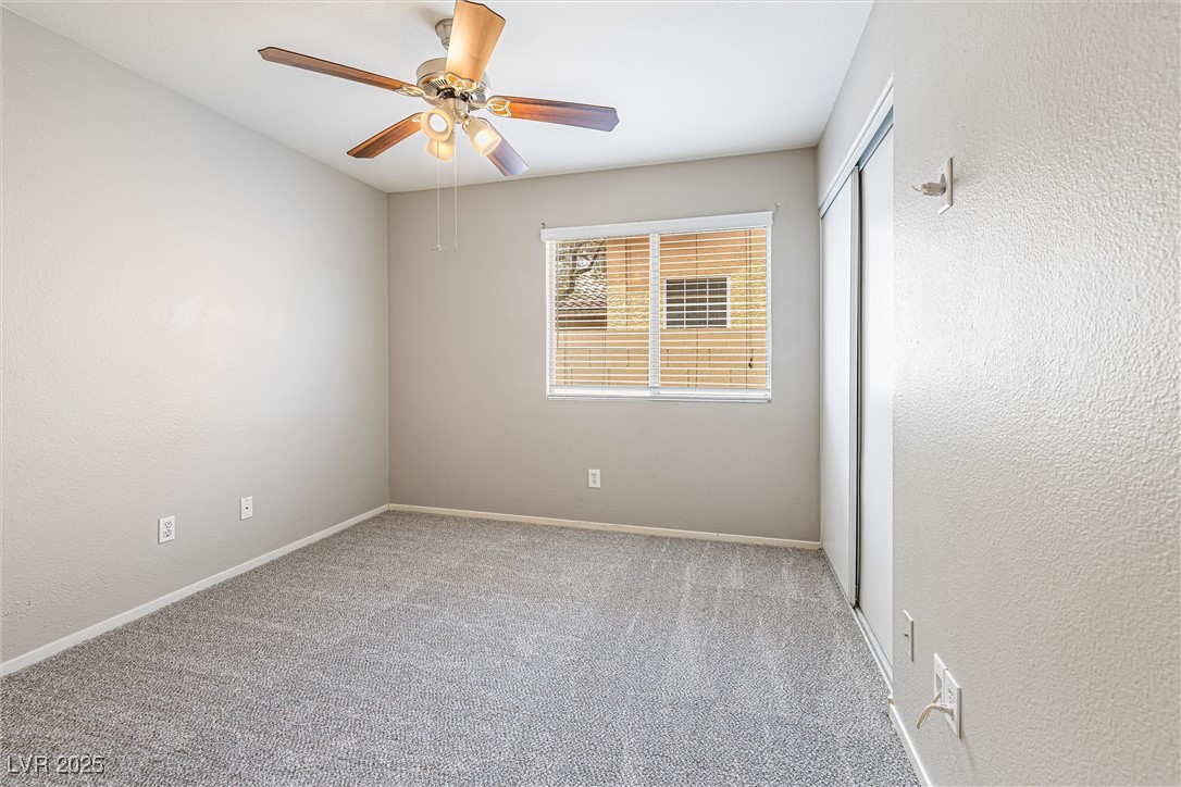 8878 Haviland Road Las Vegas, NV 89123 - Photo 34 of 58 Empty room featuring a textured wall, carpet flooring, and ceiling fan