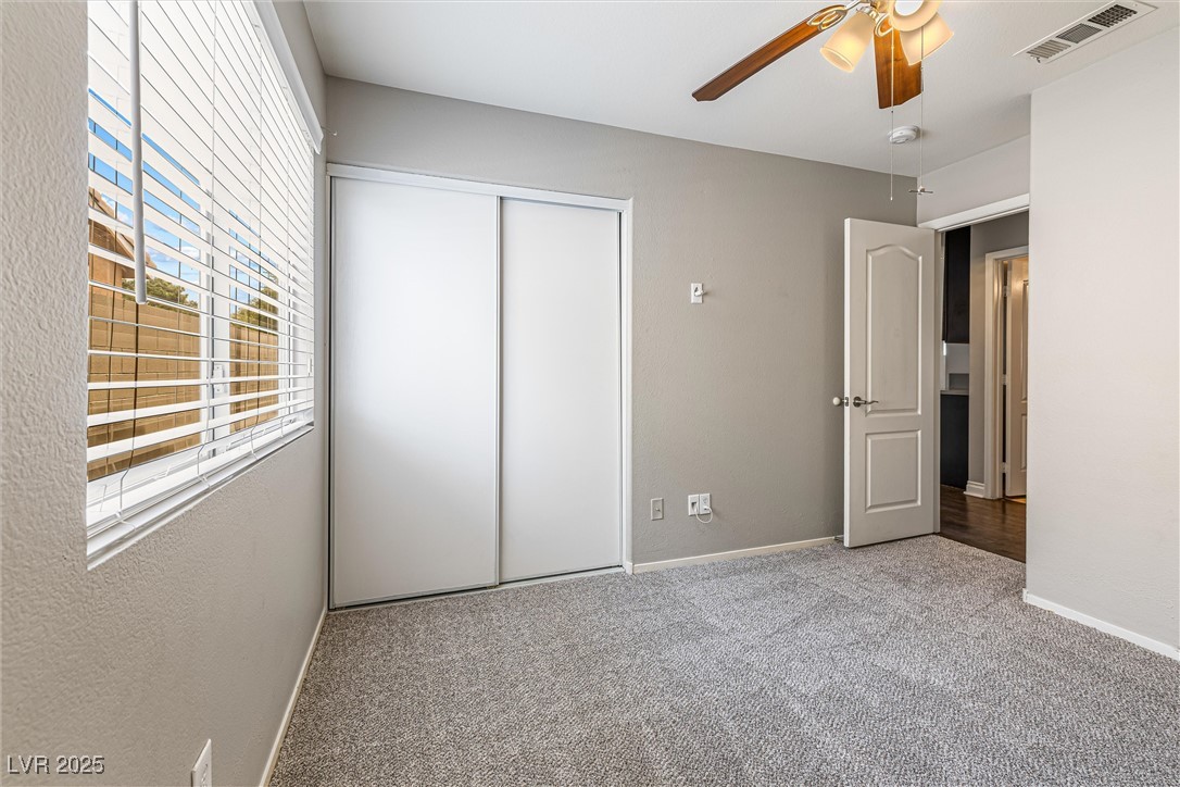 8878 Haviland Road Las Vegas, NV 89123 - Photo 36 of 58 Unfurnished bedroom with carpet flooring, a closet, and ceiling fan