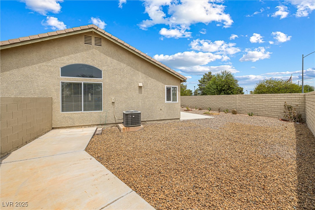 8878 Haviland Road Las Vegas, NV 89123 - Photo 38 of 58 View of property exterior with stucco siding, a patio, and a fenced backyard