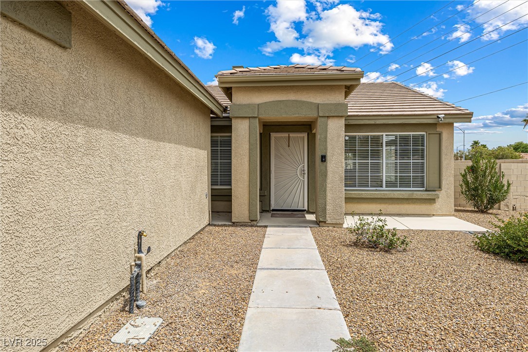 8878 Haviland Road Las Vegas, NV 89123 - Photo 6 of 58 Doorway to property featuring stucco siding and a tiled roof