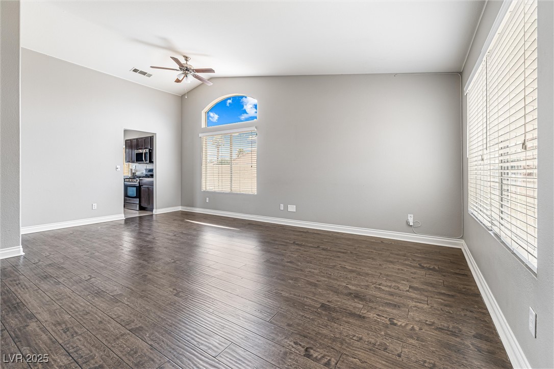 8878 Haviland Road Las Vegas, NV 89123 - Photo 7 of 58 Unfurnished room featuring lofted ceiling, dark wood finished floors, and a ceiling fan