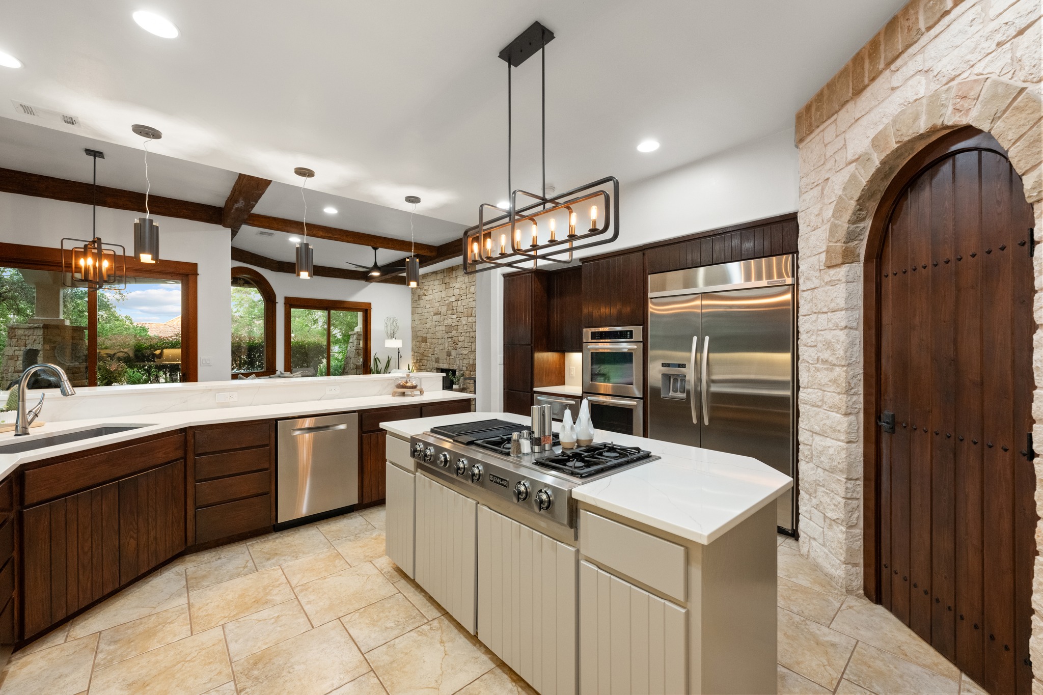 407 Hurst Creek Road Lakeway, TX 78734 - Photo 10 of 40 Natural stone accents and a curved door leading to a generously sized pantry.