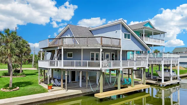 a view of a house with a yard and balcony