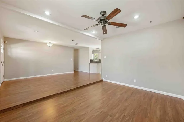 a view of a kitchen with a sink and wooden floor