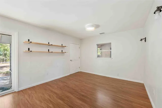 a large kitchen with kitchen island a large window a sink and stainless steel appliances