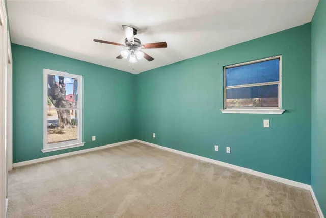 a view of an empty room with a fan