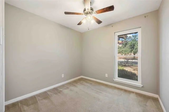 a view of a house with backyard and a tree