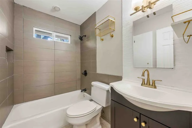 a view of a house with a tree in front of it