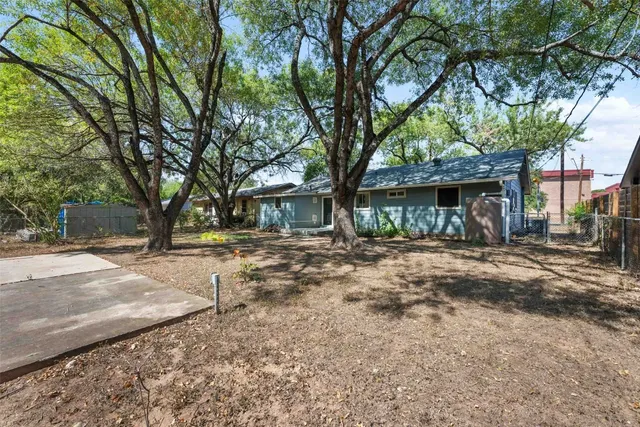an aerial view of residential houses with outdoor space and river