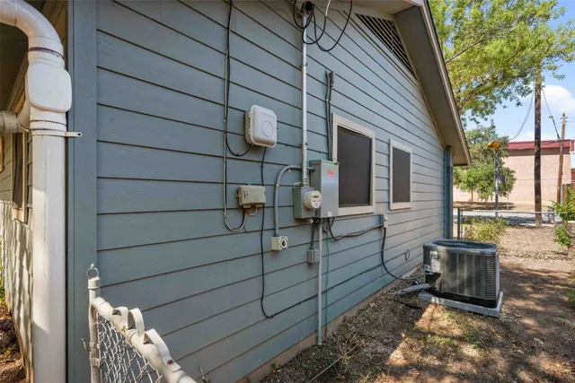 an aerial view of residential house with outdoor space and trees all around