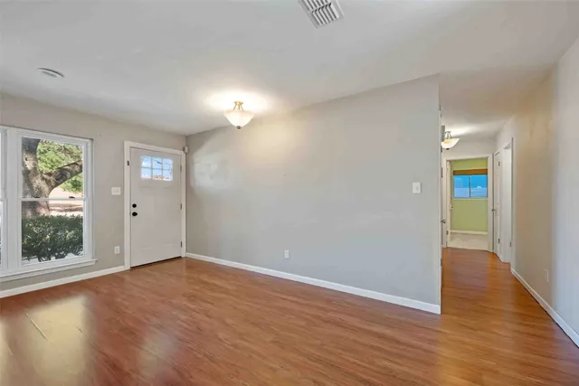 a view of a room with wooden floor