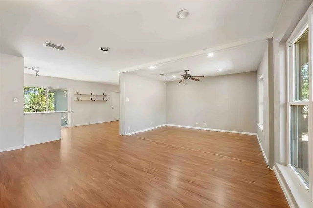 wooden floor in an empty room with a window