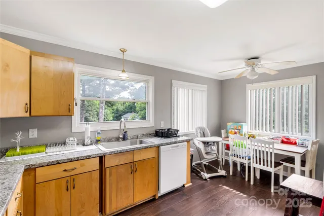 a kitchen with a sink stove top oven and cabinets