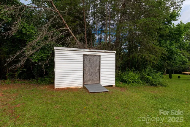 a view of a house with a yard and sitting area