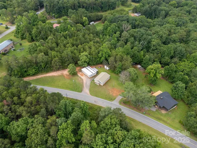 an aerial view of a house with outdoor space and street view