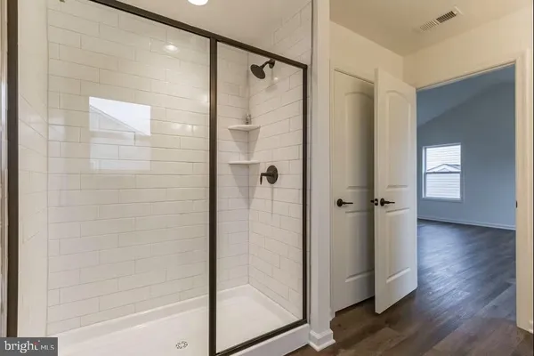 a bathroom with a glass shower door