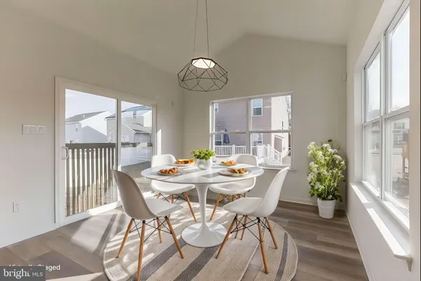 a view of a dining room with furniture wooden floor and a chandelier